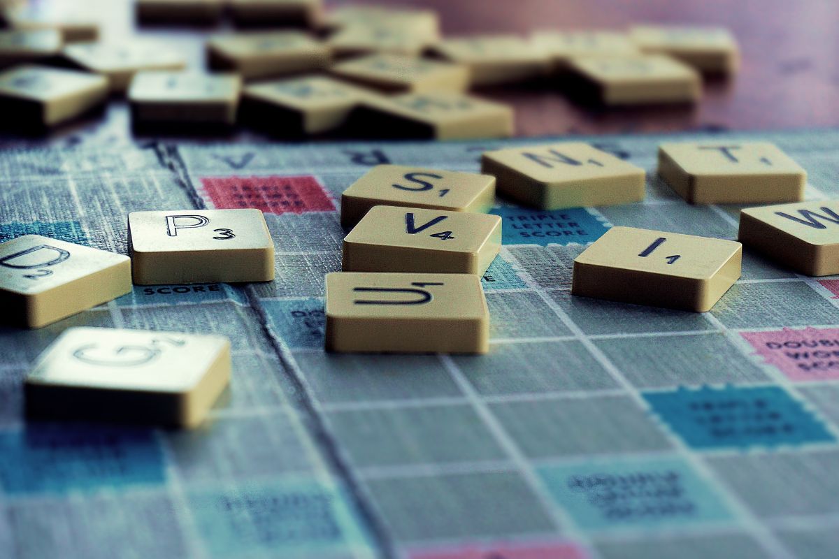 Scrabble pieces scattered on a Scrabble board