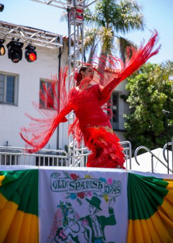 Dancer in a red dress on an Old Spanish Days stage 