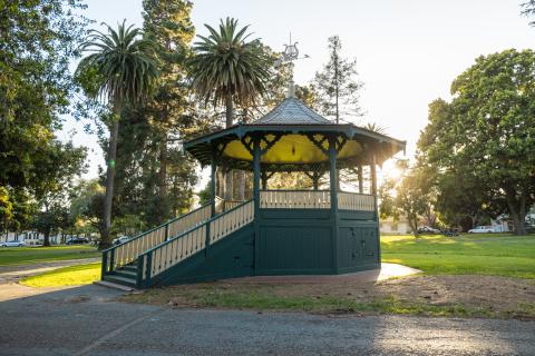 Alameda Park Bandstand with weathervane on top and grassy area around