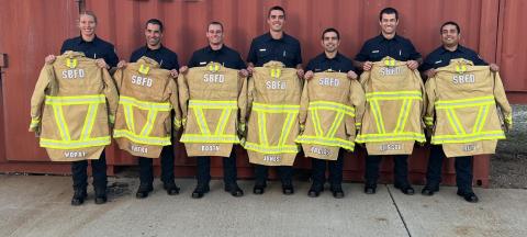 Santa Barbara City Fire Department gear issue to recruits. Recruits holding jackets.