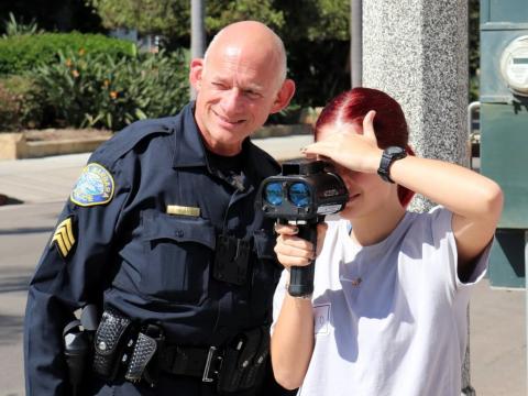 Community Academy Participant Using the Lidar Radar Gun