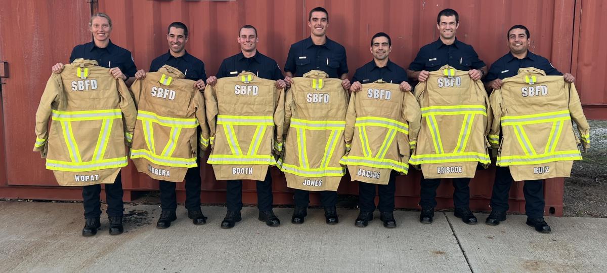 Santa Barbara City Fire Department gear issue to recruits. Recruits holding jackets.