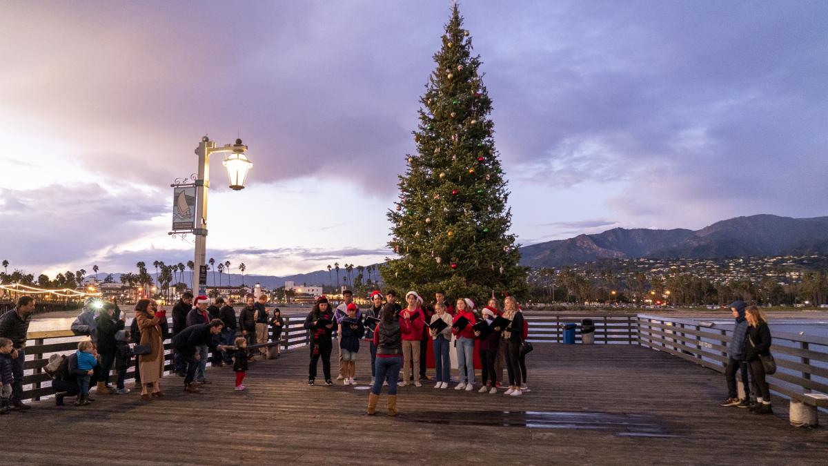 Dos Pueblos Jazz Choir Signs in front of Stearns Wharf Holiday Tree
